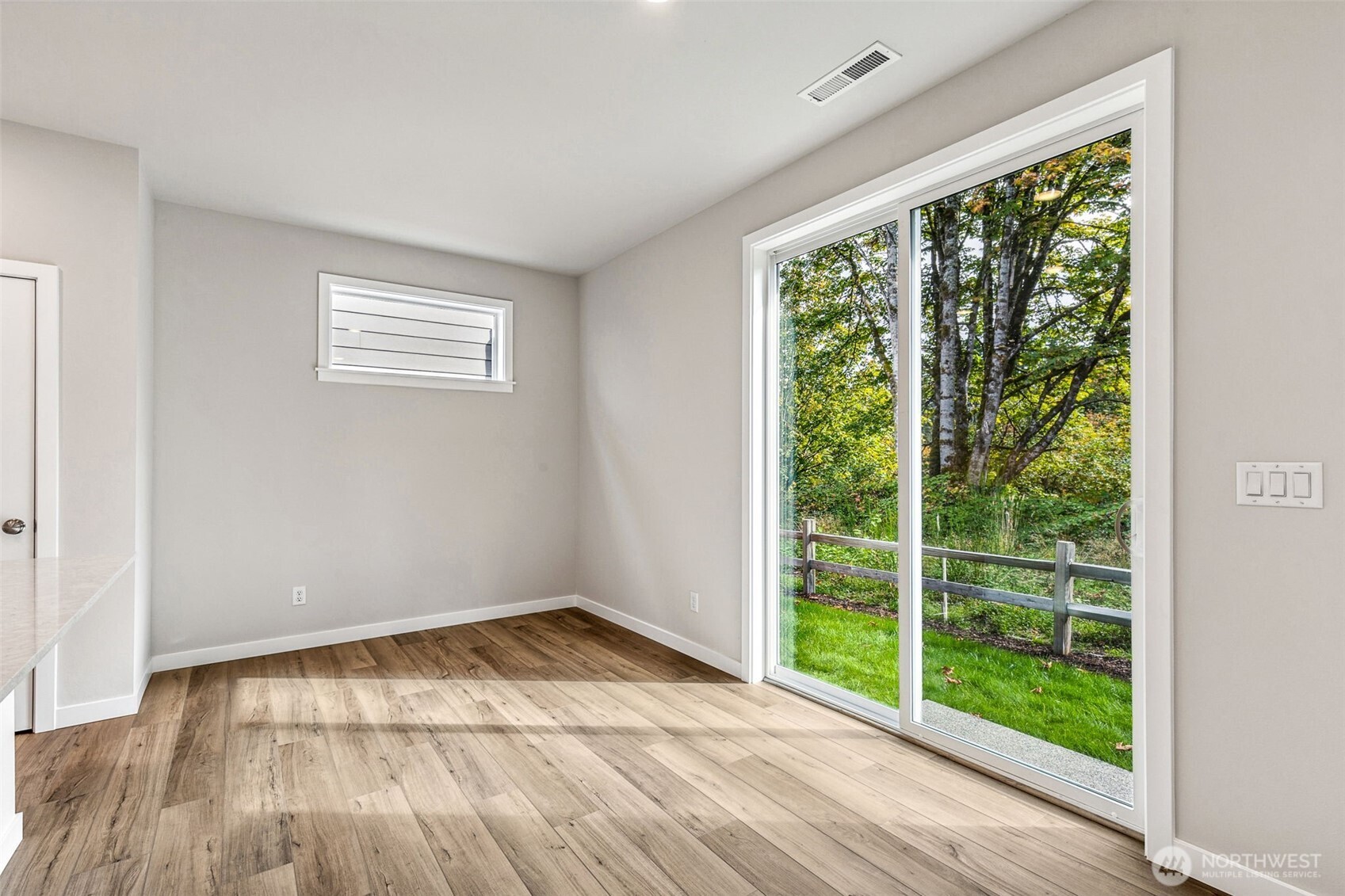 13406 323rd Drive Southeast Sultan, WA 98294 - Photo 12 of 29 a view of an empty room with wooden floor and a window
