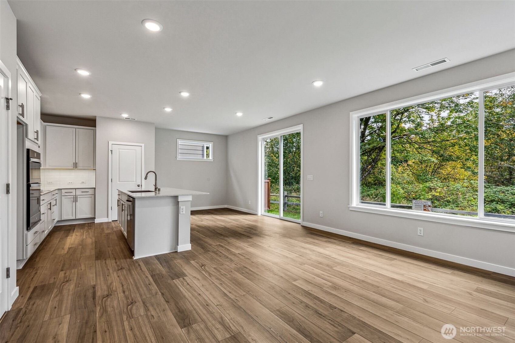 13406 323rd Drive Southeast Sultan, WA 98294 - Photo 5 of 29 a view of a kitchen with wooden floor and a window