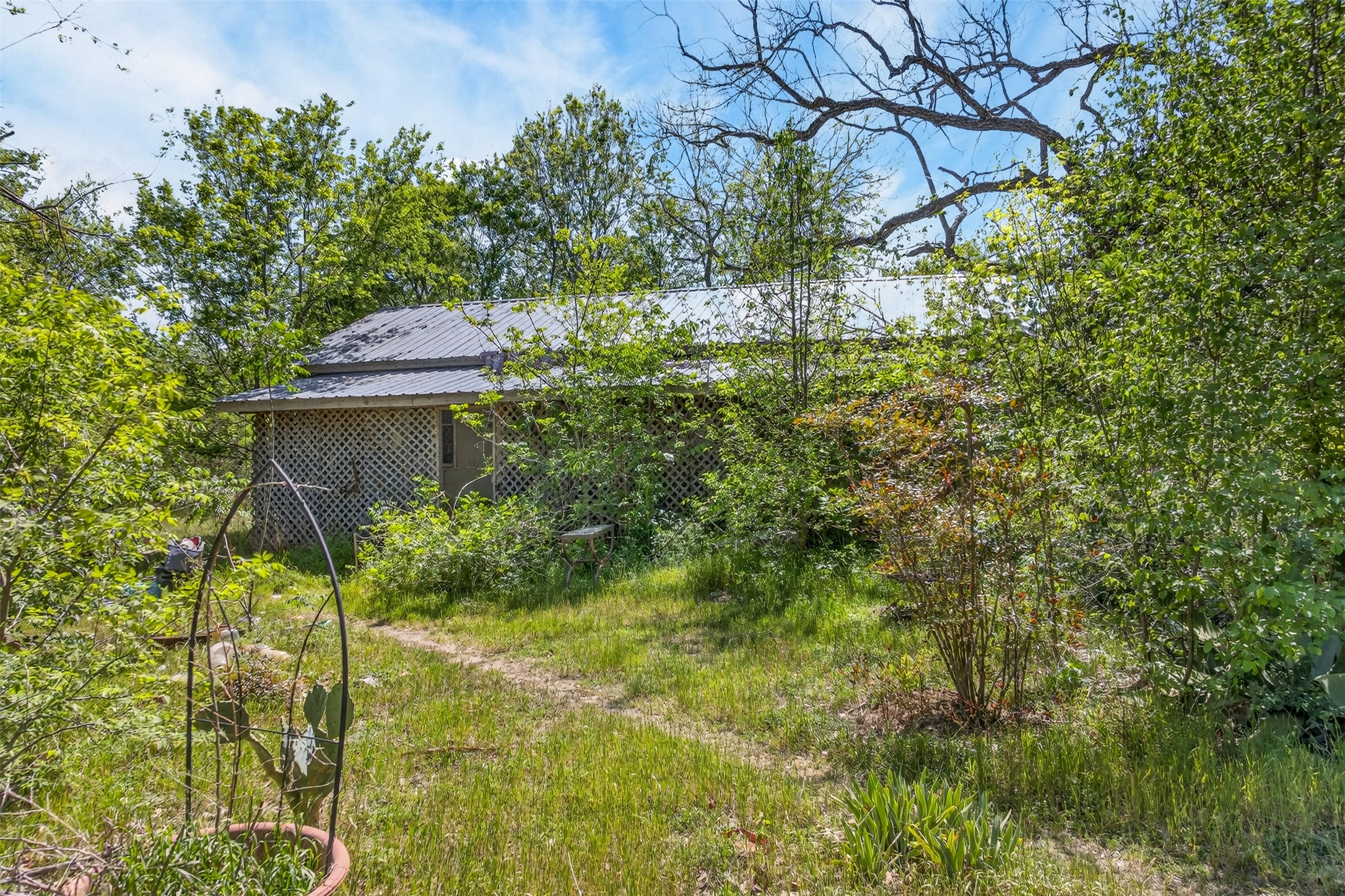 0 Fm 1854 Rd Dale Dale, TX 78616 - Photo 11 of 29 a backyard of a house with table and chairs under an umbrella