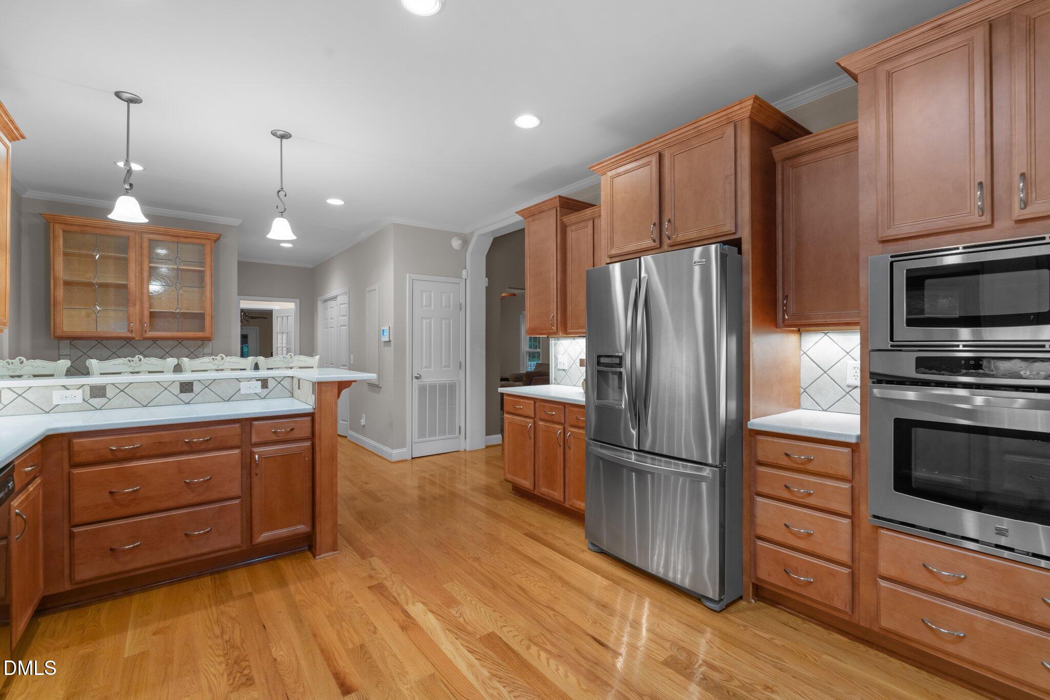 431 Patterson Ridge Lane Sanford, NC 27330 - Photo 6 of 29 a kitchen with granite countertop a refrigerator stove and oven