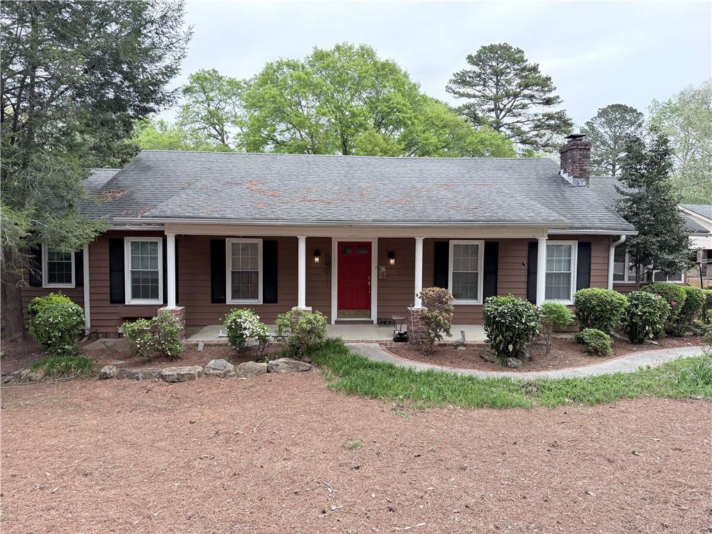 3033 Riviera Drive Conyers, GA 30012 - Photo 2 of 79 a front view of a house with garden and porch