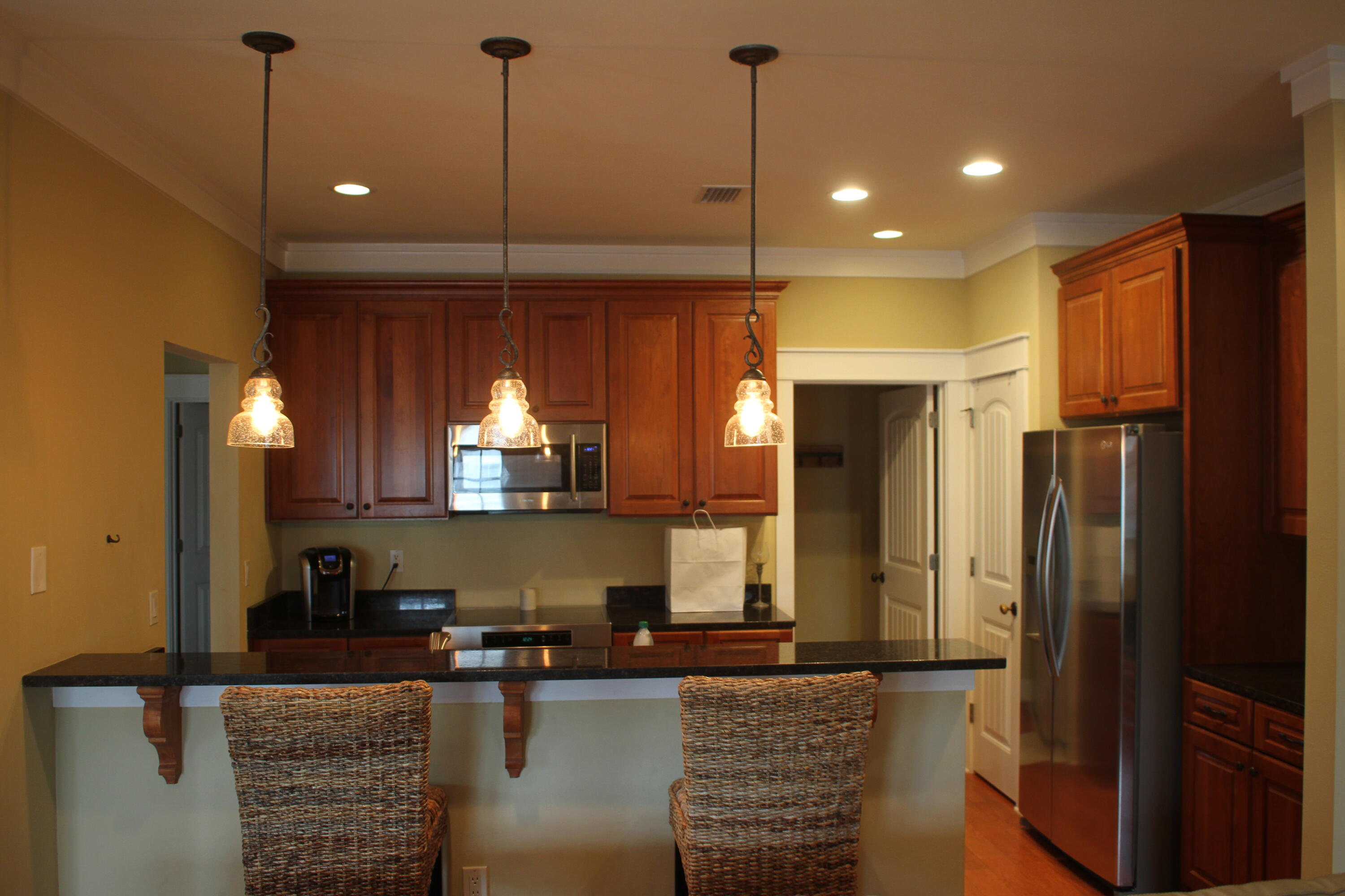 59 Willow Mist Road Inlet Beach, FL 32461 - Photo 9 of 22 a kitchen with kitchen island granite countertop a refrigerator a sink and a stove