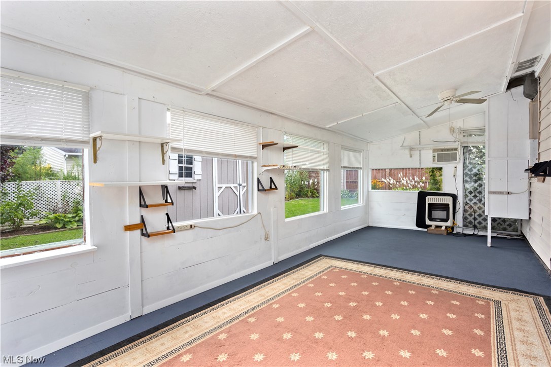 387 Fairfax Road Vermilion, OH 44089 - Photo 31 of 35 Sunroom with a wealth of natural light, a wall mounted air conditioner, and lofted ceiling