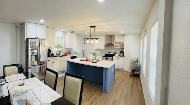 a kitchen with a sink refrigerator and cabinets