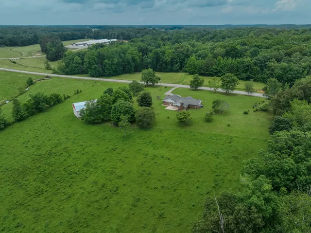 a view of a green field with wooden fence