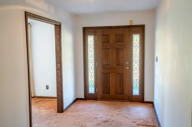 a view of a kitchen with a sink a refrigerator and a stove top oven