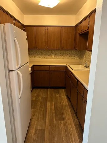 a kitchen with a refrigerator and a sink