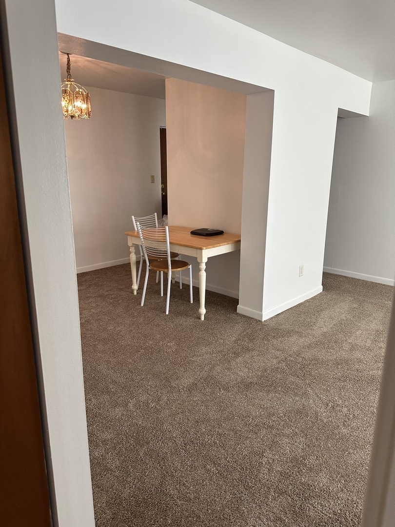 222 Madison Street, Unit 208 Joliet, IL 60435 - Photo 5 of 20 a view of a room with a table and chairs
