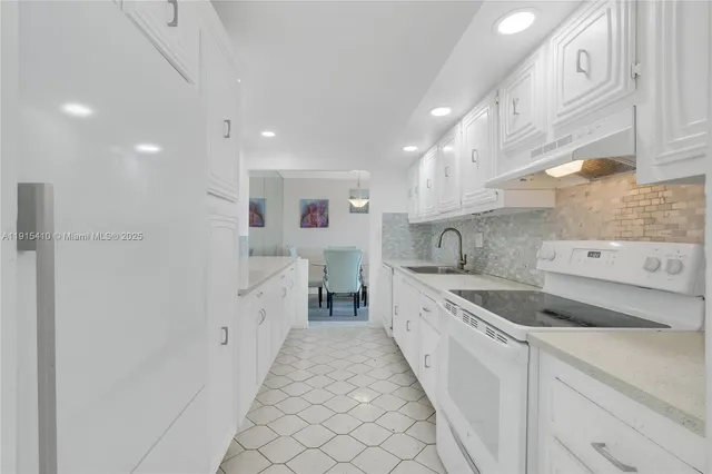 a large kitchen with a sink and cabinets