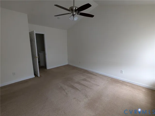an empty room with a ceiling fan and a window