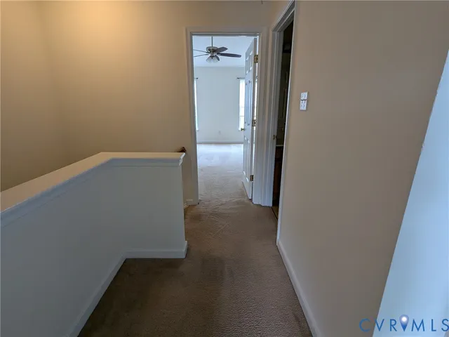 a view of a house with a yard and potted plants