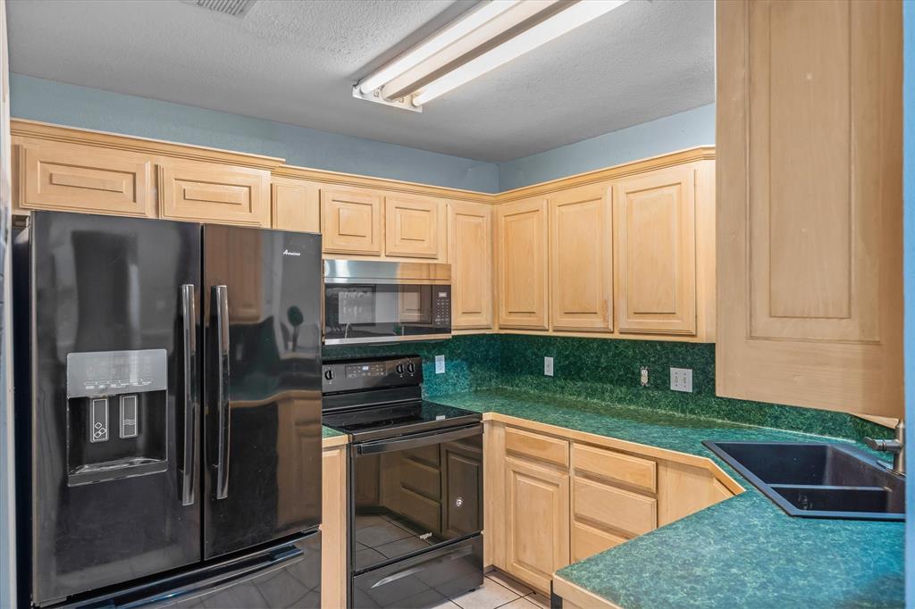 560 Washington Street Van, TX 75790 - Photo 12 of 29 a kitchen with stainless steel appliances granite countertop a refrigerator and a sink