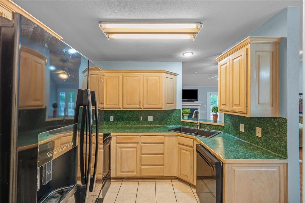 560 Washington Street Van, TX 75790 - Photo 13 of 29 a kitchen with a sink a counter top space cabinets and stainless steel appliances