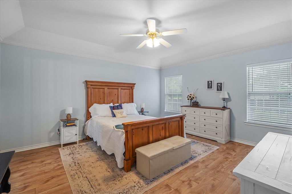 560 Washington Street Van, TX 75790 - Photo 20 of 29 a spacious bedroom with a large bed and a chandelier