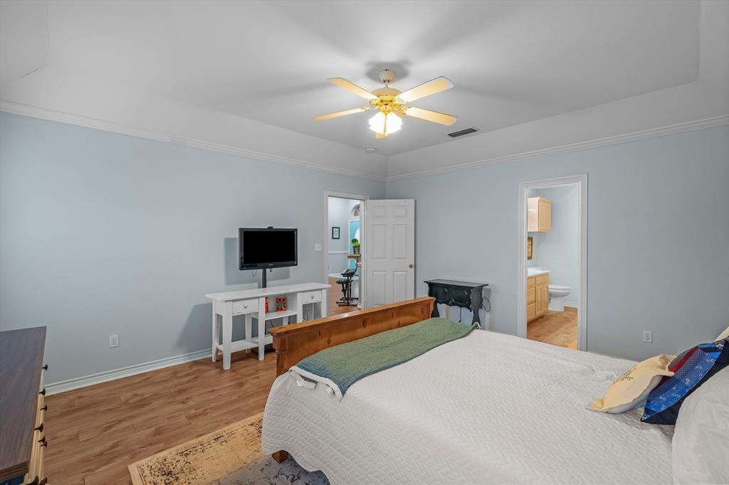560 Washington Street Van, TX 75790 - Photo 21 of 29 a bedroom with a bed and a flat screen tv
