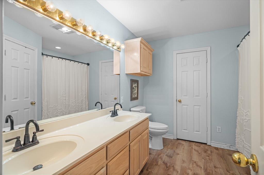 560 Washington Street Van, TX 75790 - Photo 22 of 29 a bathroom with a sink and a large mirror