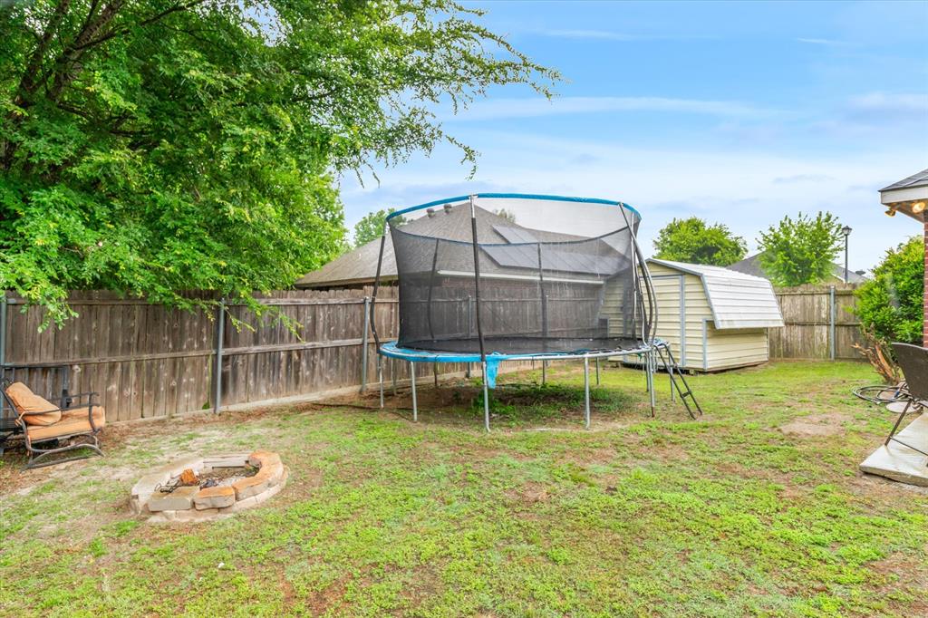 560 Washington Street Van, TX 75790 - Photo 25 of 29 a backyard of a house with table and chairs