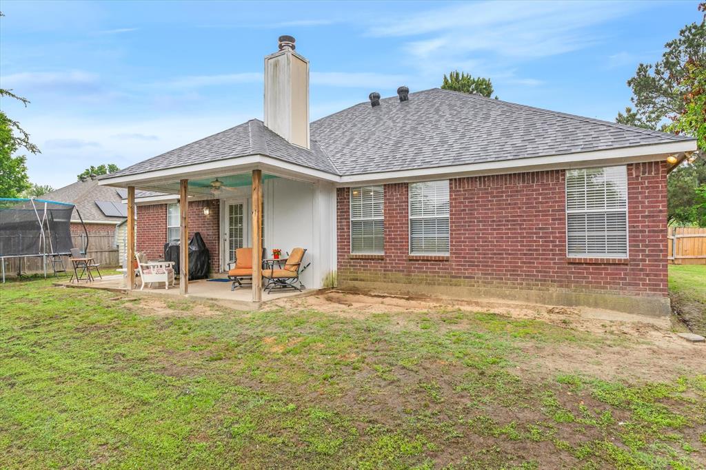 560 Washington Street Van, TX 75790 - Photo 27 of 29 a front view of a house with a garden and patio