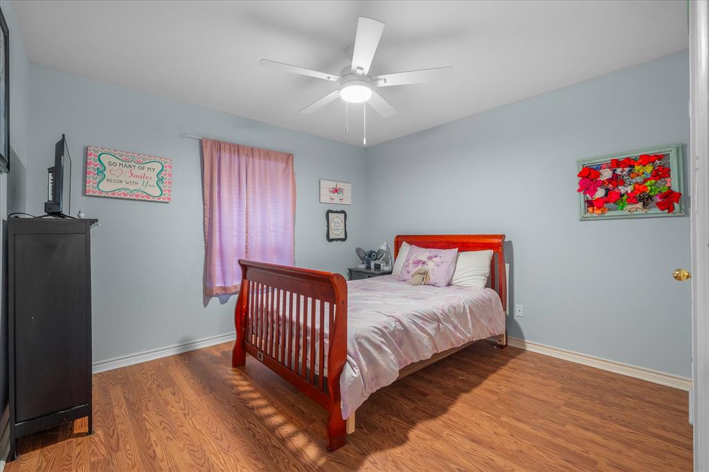560 Washington Street Van, TX 75790 - Photo 10 of 29 a bedroom with a bed and a chandelier
