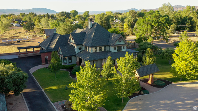 426 West Center Street Parowan, UT 84761 - Photo 93 of 107 Stately residence featuring a multi-gabled roofline, stone and siding exterior, expansive driveway, and mature landscaping