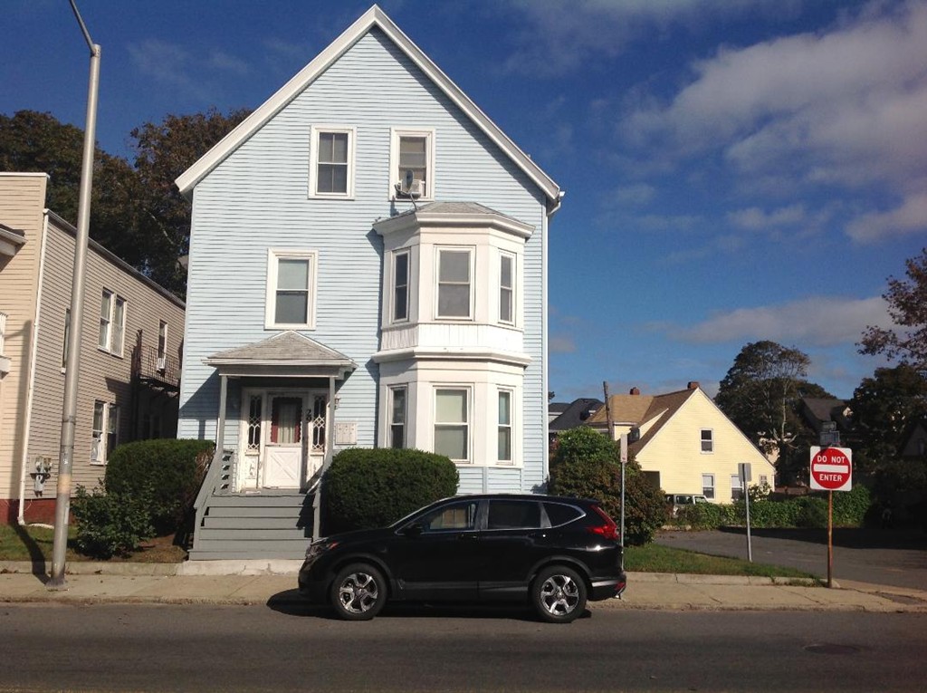 29 Lewis Street, Unit 2 Lynn, MA 01902 - Photo 1 of 22 a car parked in front of a white house