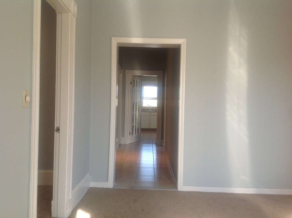 29 Lewis Street, Unit 2 Lynn, MA 01902 - Photo 14 of 22 a view of a hallway with wooden floor and a cabinet