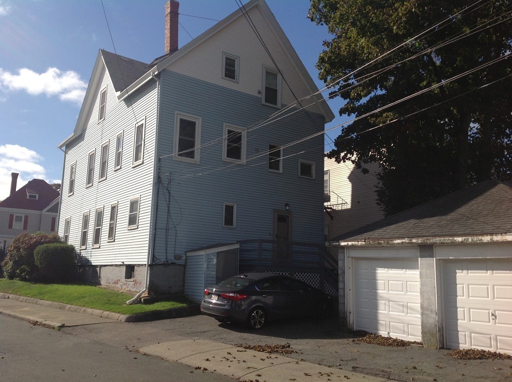 29 Lewis Street, Unit 2 Lynn, MA 01902 - Photo 3 of 22 a car parked in front of a white house