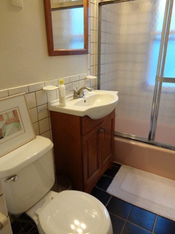 29 Lewis Street, Unit 2 Lynn, MA 01902 - Photo 10 of 22 a bathroom with a sink a toilet and a mirror