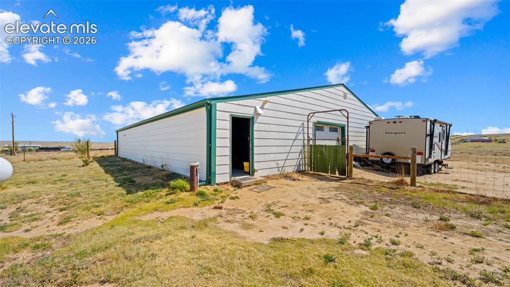 33975 Highway 94 Yoder, CO 80864 - Photo 20 of 40 Outbuilding with white siding, green trim, and a metal roof
