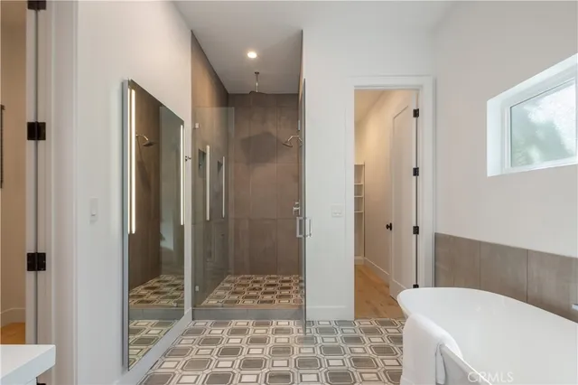 a bathroom with double vanity sinks and a mirror