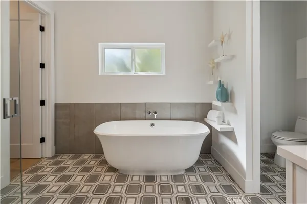 a bathroom with a tub sink and mirror
