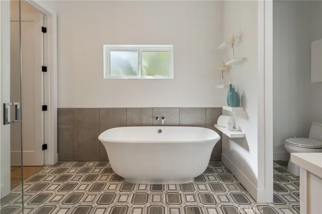 a bathroom with a tub sink and mirror