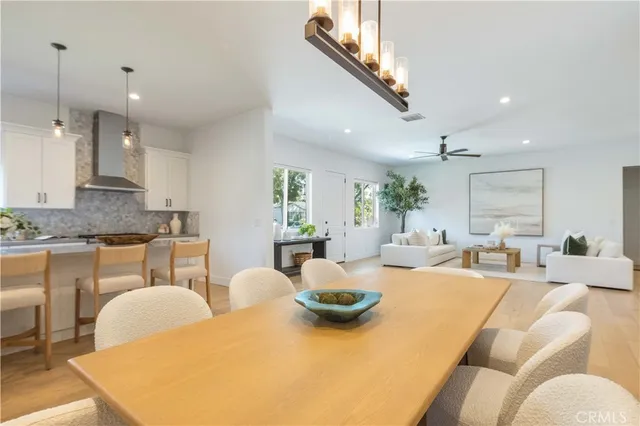 a large kitchen with a table and chairs