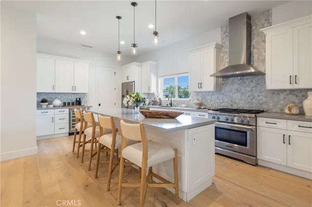 a open kitchen with a sink a stove and chairs