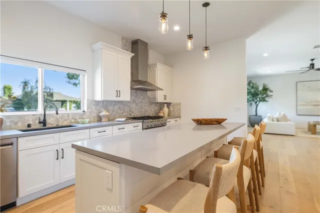 a kitchen with granite countertop white cabinets and chairs