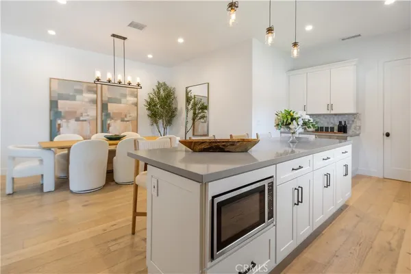 a kitchen with granite countertop stainless steel appliances a stove a sink a counter space and cabinets