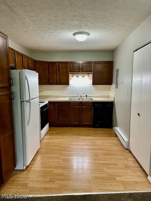 4376 Darrow Road, Unit 7 Stow, OH 44224 - Photo 5 of 23 Kitchen with decorative backsplash, light hardwood / wood-style floors, white appliances, baseboard heating, and sink