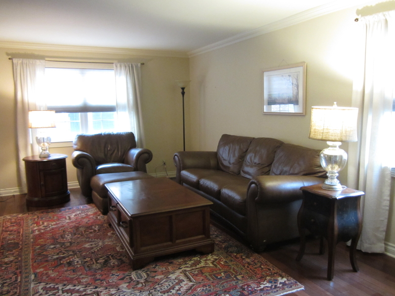 67 New England Avenue, Unit F Summit, NJ 07901 - Photo 4 of 16 a living room with furniture and a window
