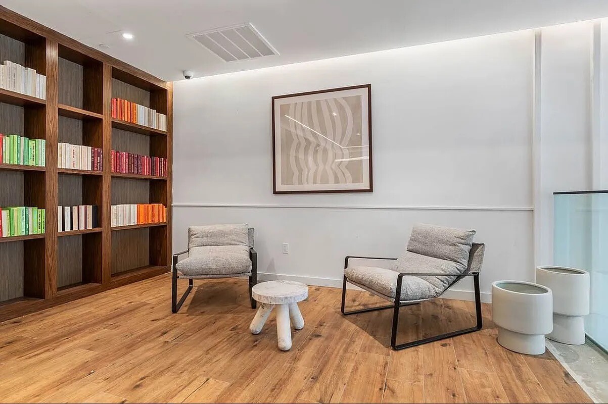 161 Lenox Road, Unit 512 Brooklyn, NY 11226 - Photo 12 of 13 a living room with furniture and a book shelf