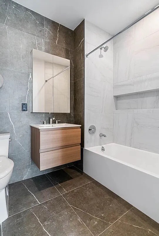 161 Lenox Road, Unit 512 Brooklyn, NY 11226 - Photo 7 of 13 a bathroom with a bathtub and a toilet