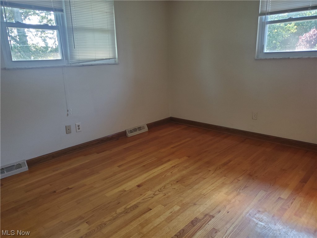 12221 Reno Drive Parma, OH 44130 - Photo 24 of 29 Spare room featuring a wealth of natural light and light hardwood flooring