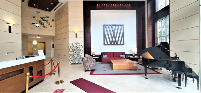 a living room with furniture and floor to ceiling windows