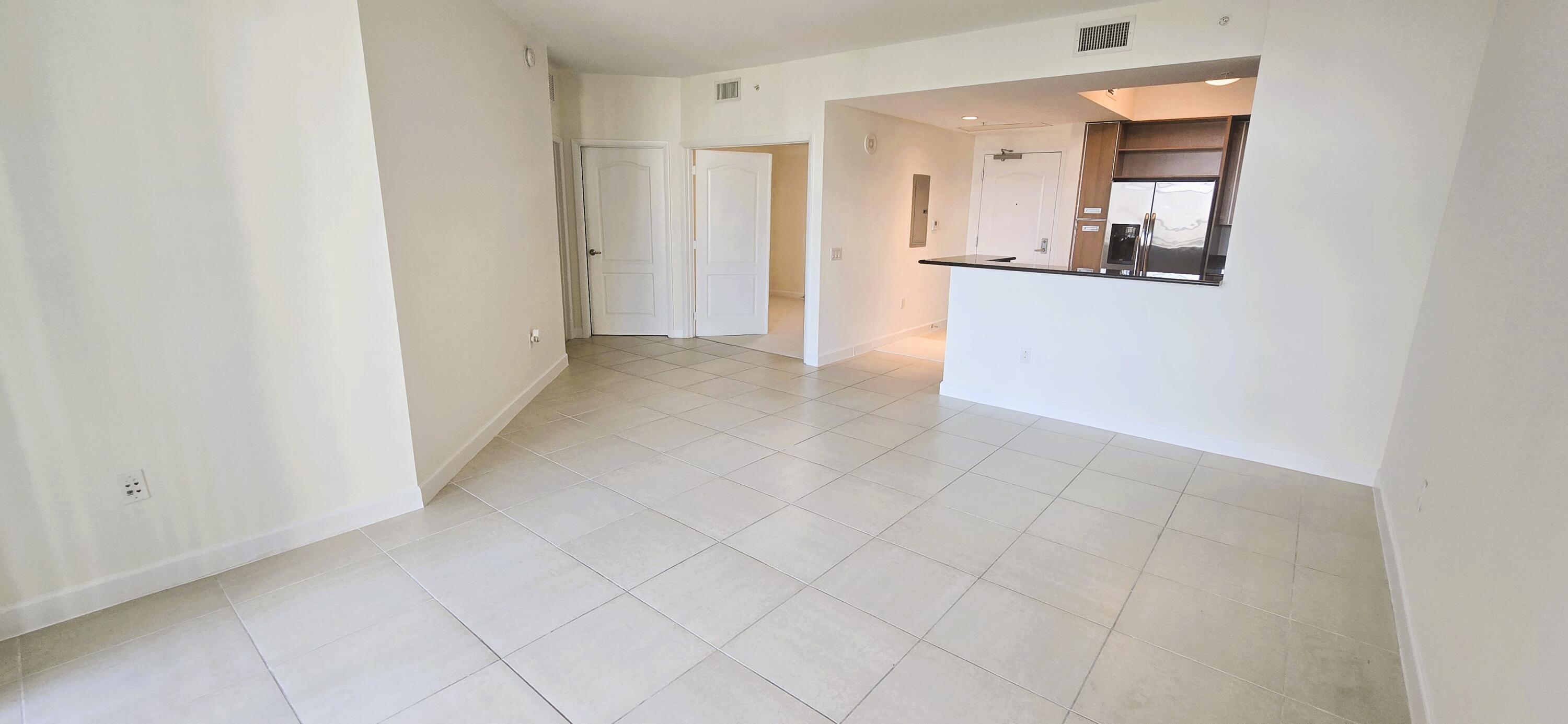 410 Evernia Street, Unit 616 West Palm Beach, FL 33401 - Photo 3 of 23 a view of a hallway with wooden floor and a living room
