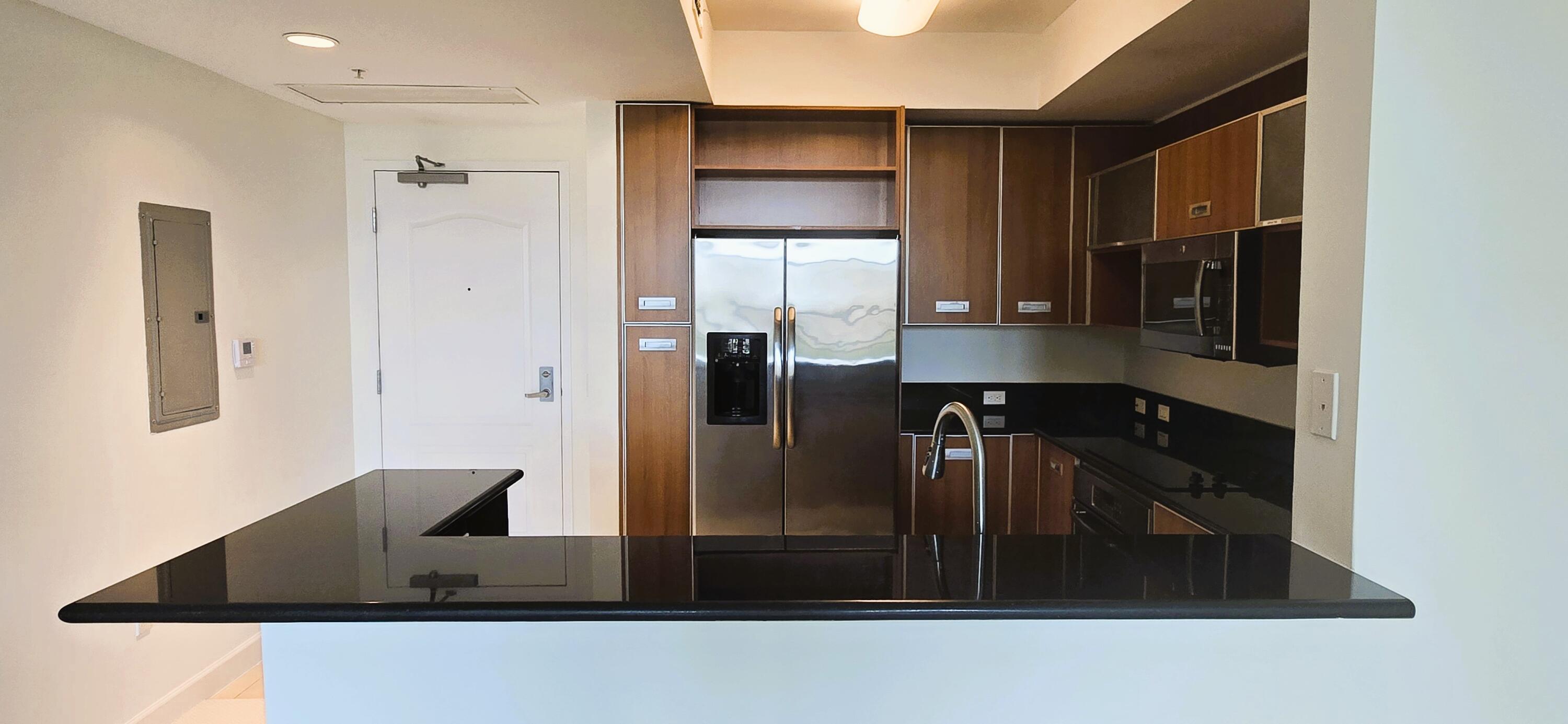 410 Evernia Street, Unit 616 West Palm Beach, FL 33401 - Photo 4 of 23 a kitchen with stainless steel appliances granite countertop a refrigerator and a stove