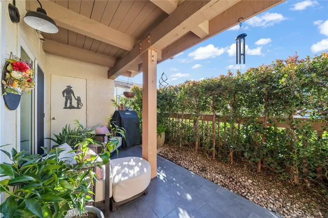 a porch with furniture and potted plant