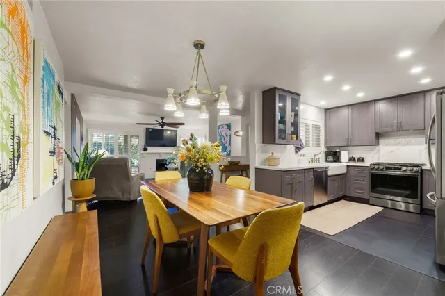 a view of a dining room with furniture and a chandelier