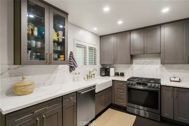 a kitchen with a sink appliances and cabinets