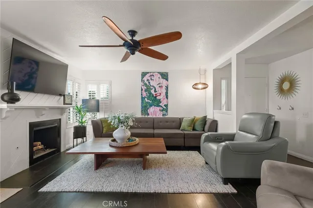 a living room with furniture a fireplace and a flat screen tv