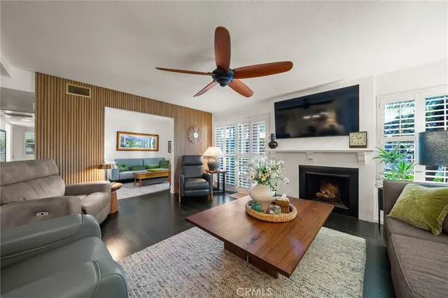 a living room with furniture a flat screen tv and a fireplace