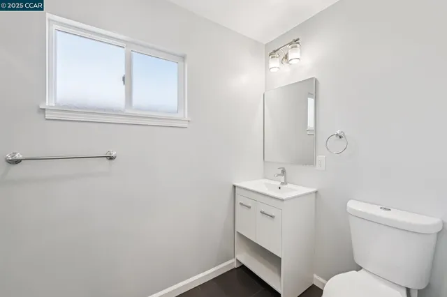a bathroom with a toilet sink and mirror